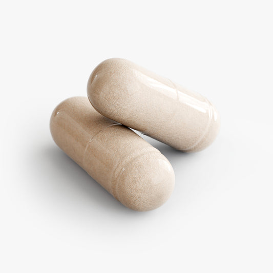 Two beige Sea Moss capsules from The Unruffled State are stacked on a plain white background.